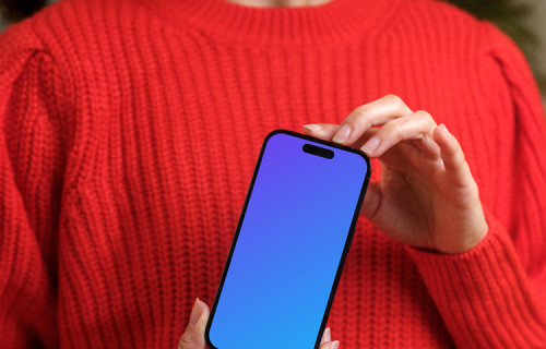 Woman in red sweater holding an iPhone 14 Pro mockup