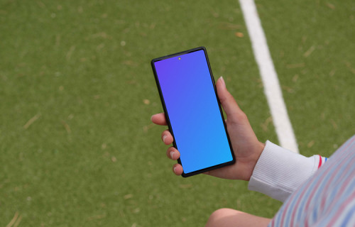 Young footbal player checking on a Google Pixel 6 mockup