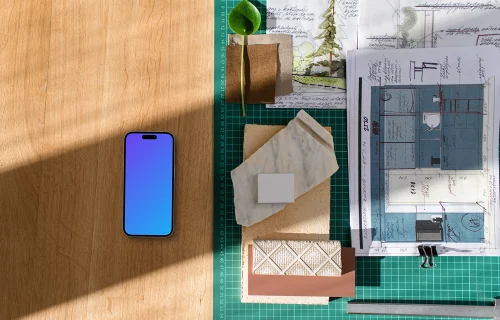 Architect's smartphone mockup on a wooden desk with blueprints