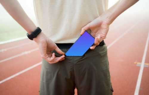 Athlete putting a phone in the pocket mockup