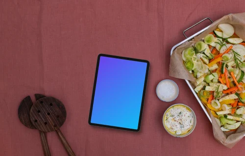 Baking pan full of vegetables and a tablet mockup
