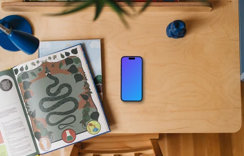 Children's book and smartphone mockup on wooden table
