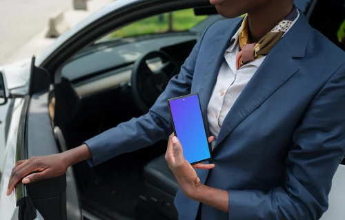 Entrepreneur next to the Tesla holding a Google Pixel 6 mockup