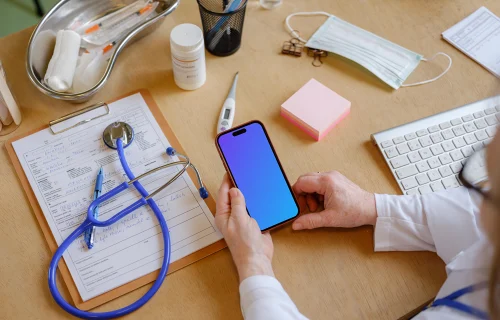 Female doctor holding an iPhone