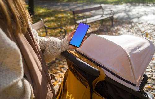 Female hand holding a Google Pixel 6 during autumn mockup