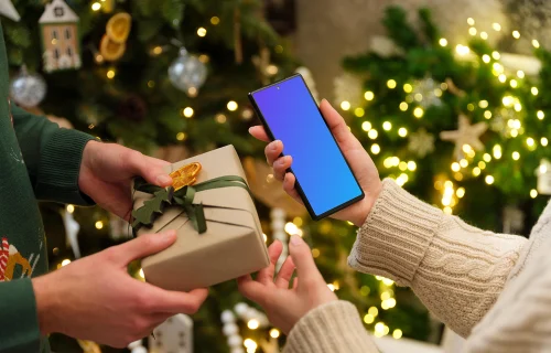 Female holding a smartphone mockup in Christmas theme