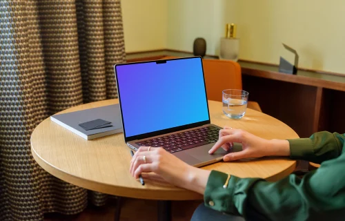 Female in the office working on a MacBook mockup