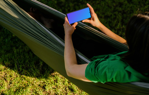 Female laying in a hammock while holding a Google Pixel 6 mockup
