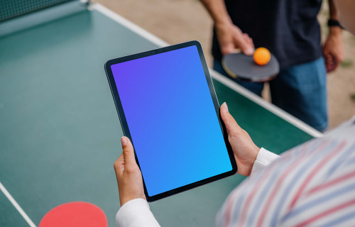 Female ping-pong player holding a tablet mockup