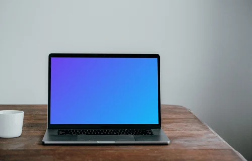 Front view of MacBook Pro mockup on a wooden table