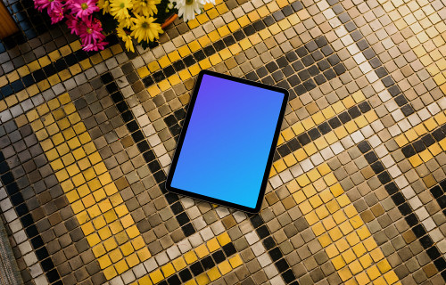 iPad Air mockup on a colorful garden paving with flowers