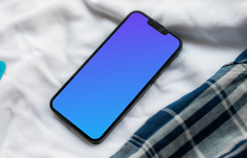 iPhone 13 mockup on bed