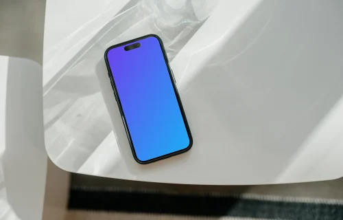 iPhone 15 Pro mockup on a white modern table