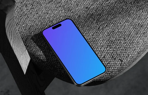 iPhone 15 Pro mockup on textured rock surface with dramatic lighting