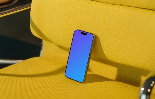 iPhone 15 Pro mockup on yellow armchair