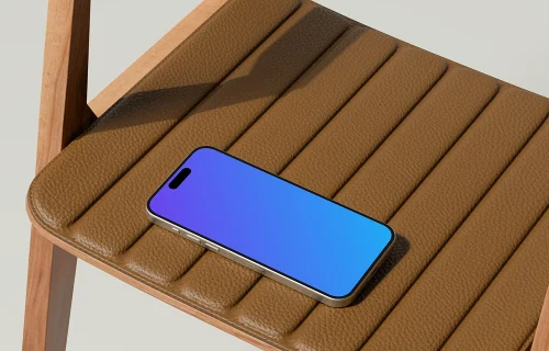 iPhone 16 mockup on a leather chair