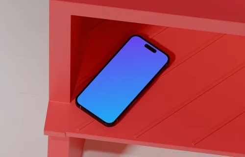 iPhone 16 mockup on a red shelf