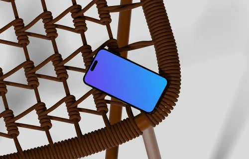 iPhone 16 mockup on a woven chair