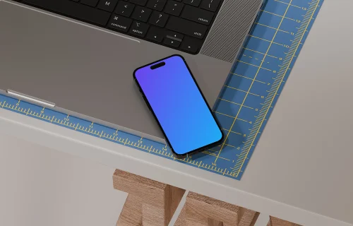 iPhone 16 mockup on designer's desk