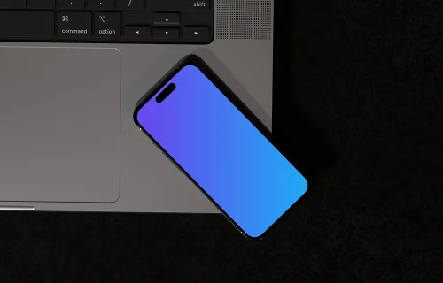 iPhone 16 mockup with laptop angle view