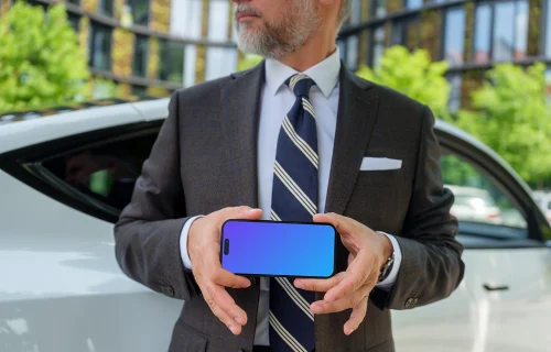 iPhone mockup in businessman’s hands