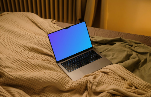 MacBook mockup on bed sheets