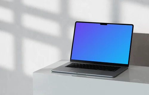 MacBook Pro 14-inch mockup on marble surface with natural shadows