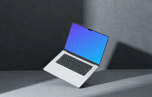 MacBook Pro 16 inch mockup on a textured gray surface with dramatic lighting