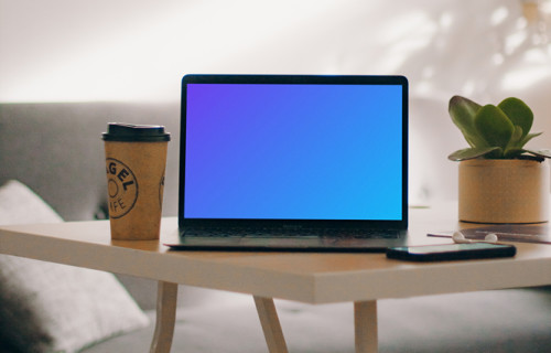 MacBook Pro mockup beside a cup of coffee