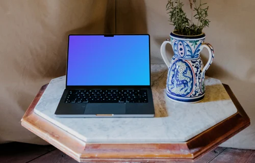 MacBook Pro mockup next to a potted plant