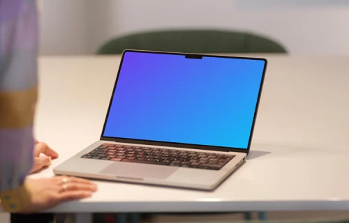 MacBook Pro Mockup on Office Desk with Person in Background