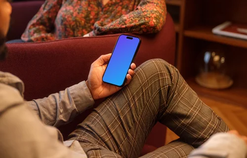 Male hand holding a phone in lounge