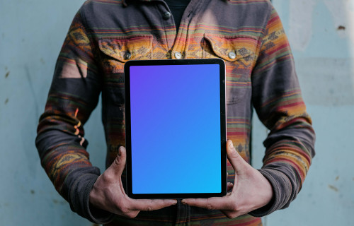 Man holding an iPad Air mockup in potrait mode