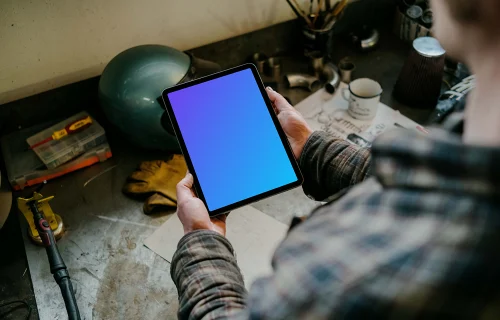 Man holding up an iPad Air mockup