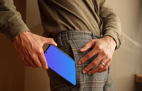 Man taking a phone mockup out of his pocket