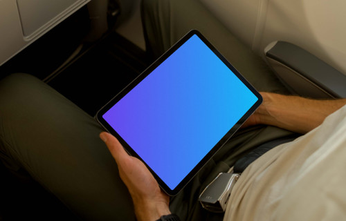 Man using a tablet mockup on an airplane