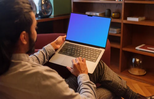 Man working on a MacBook Pro in office