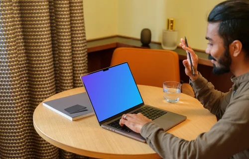 Man working on a MacBook Pro mockup in lounge 