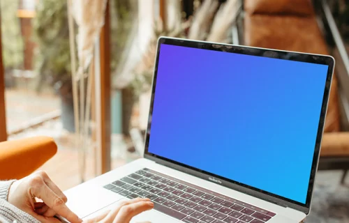 Person typing on a MacBook Pro mockup