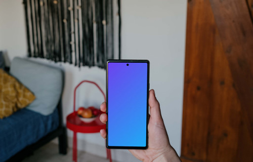 Pixel 6 mockup held by a user in a living room