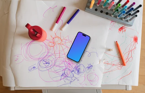 Smartphone mockup amidst colorful children's art