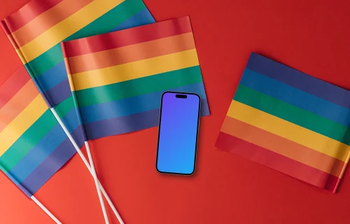 Smartphone mockup on a red surface with LGBT flags around