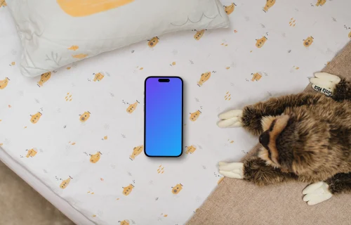 Smartphone mockup on children's bedding with plush toy