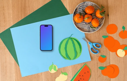 Smartphone mockup with colorful paper fruits on wooden surface