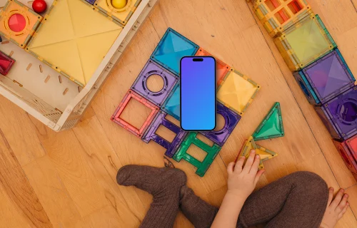 Smartphone mockup with colorful toy blocks and child's hands