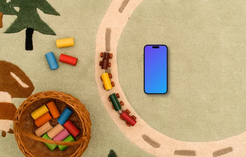 Smartphone mockup with colorful toy blocks on a child-themed rug