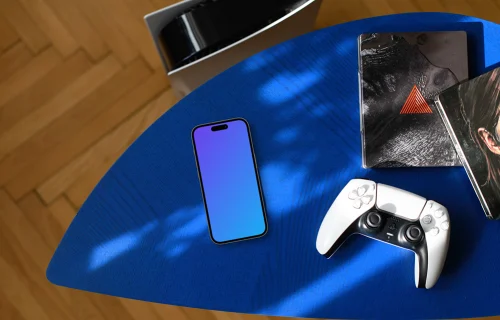 Smartphone mockup with gaming accessories on blue surface