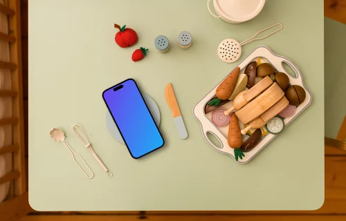 Smartphone mockup with playful wooden toy kitchen accessories