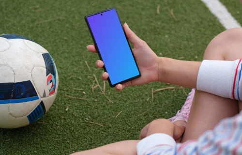 Soccer player checking on the Google Pixel 6 mockup