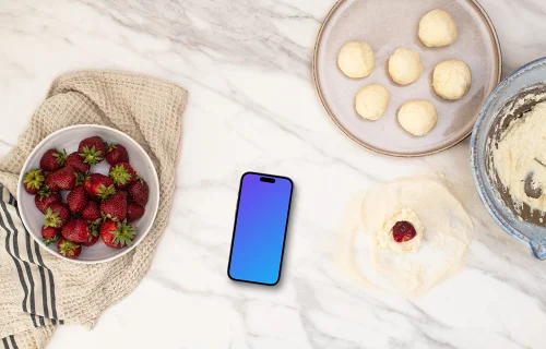 Strawberries and sweets next to the iPhone mockup